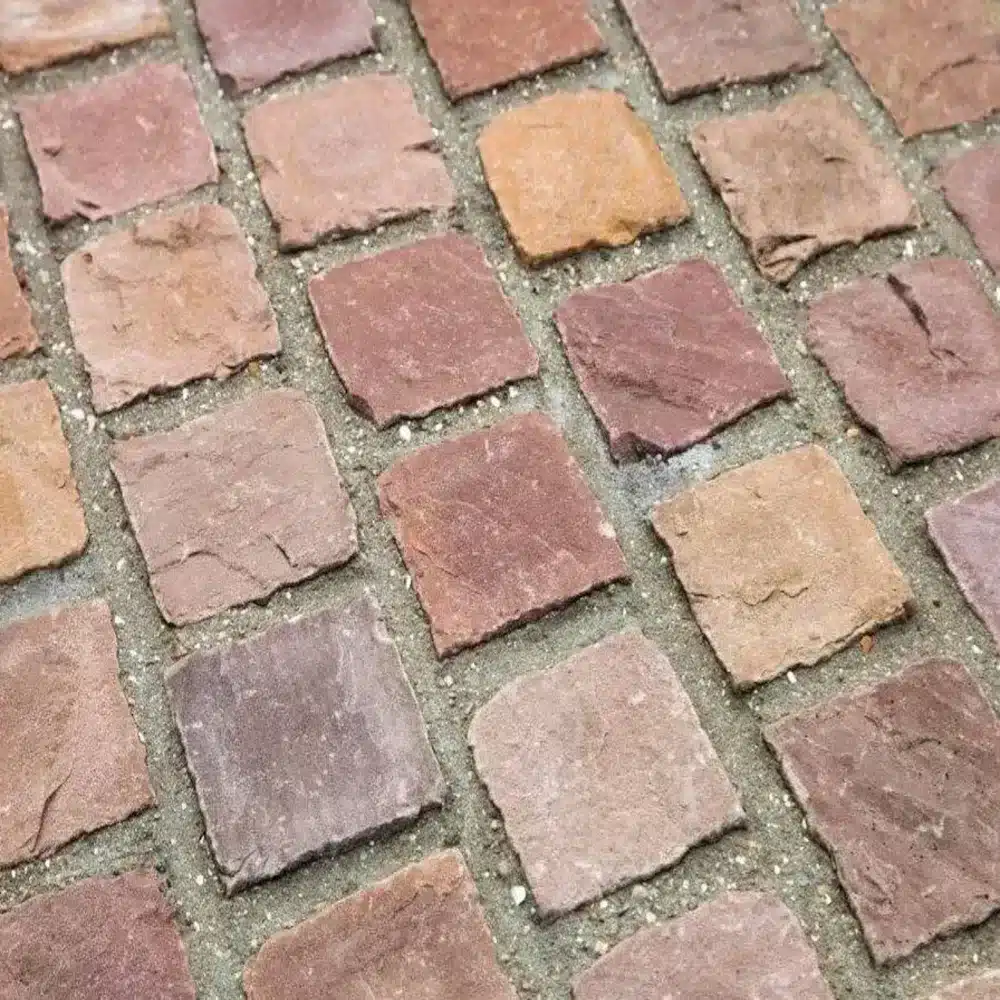 Autumn Brown sandstone cobble sett close up showing riven surface texture
