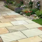 Fossil Mint Indian Sandstone paving slabs natural riven patio, in a garden setting