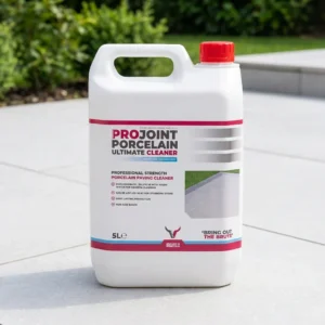 A 5-liter white container of ProJoint Porcelain Ultimate Cleaner with a red cap is on a patio surrounded by greenery. The label indicates it’s for professional porcelain paving cleaning.