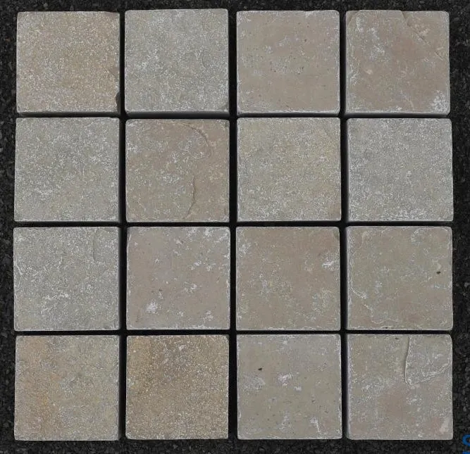 A grid of sixteen Yellow Limestone Sawn Edge Setts 100x100x40mm, each square tile featuring subtle color and texture variations, arranged in four rows and four columns against a dark background.