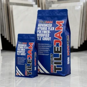Two blue bags of Nexus ProJoint Porcelain Grout - 20KG stand on a shiny tile floor with large tiles displayed in the background. The bags are labeled with bold white and red text.