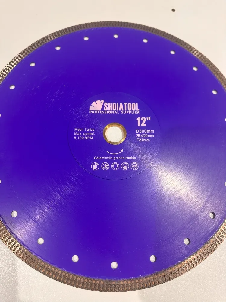 A blue circular saw blade labeled SHDIATOOL Professional Supplier, featuring a diameter of 300mm (12 inches) and a maximum speed of 5,100 RPM. Perfect for cutting ceramic, tile, granite, marble, and even natural paving materials like Indian sandstone, this Diamond Porcelain Cutting Blade adapts from a 25.4mm to a 20mm bore.