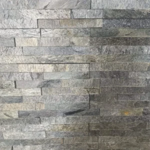 A textured wall featuring Silver Shine Stone Cladding made of rectangular grey stone tiles arranged in a staggered pattern, creating a natural and rustic appearance. The slight variation in shade among the stones gives the wall a subtle, multicolored look.