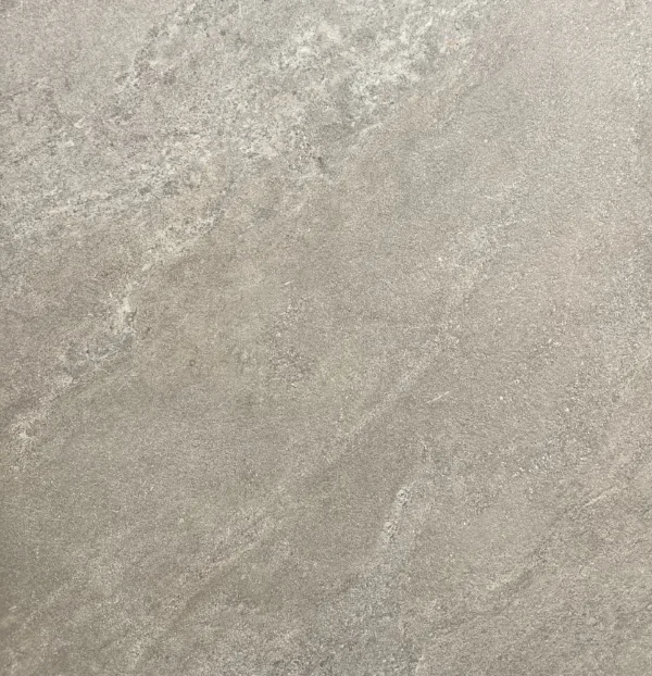 A close-up of Mocha Outdoor Porcelain Paving Tiles (600mm x 900mm x 20mm) showcases their smooth, light gray surface with subtle natural patterns and textures.